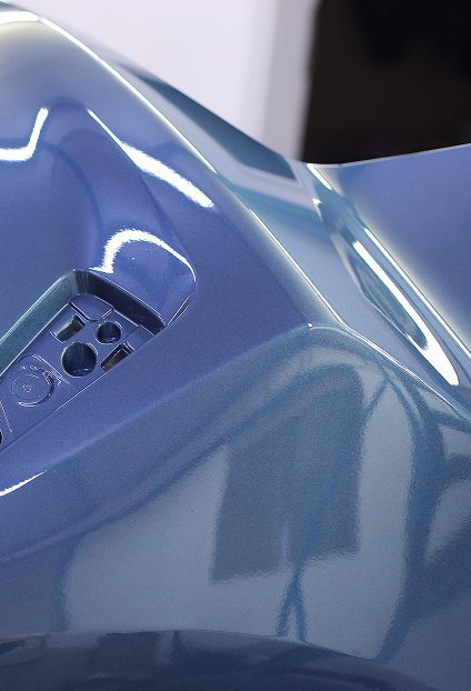 Reflective blue vehicle component surface