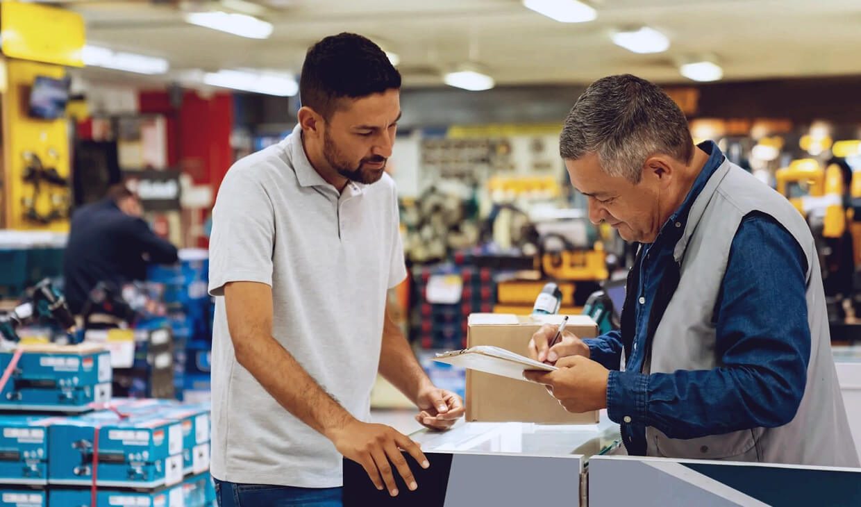 Two men discussing in a hardware store